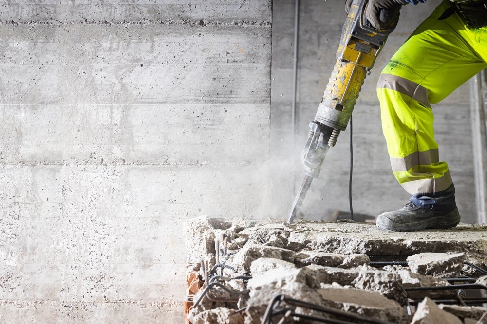 Construction,Worker,Using,Heavy-duty,Jackhammer,Tool,And,Breaking,Reinforced,Concrete.